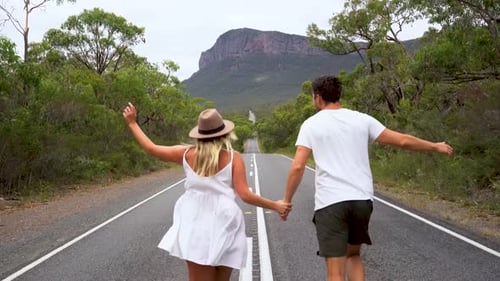 4K Sony Camera Video of a couple running down a road at the Grampians National Park, Australia