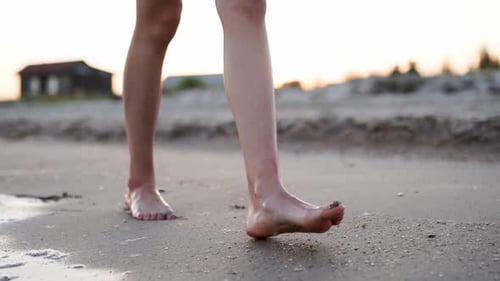 Slim Female Legs and Feet Walking Along Sea Water Waves on Sandy Beach Pretty Woman Walks at Seaside