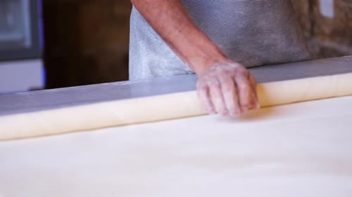 Dough Being Rolled on a Kitchen Table