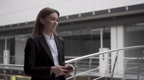 Successful Ambitious Young Woman Recruiter Walking in Workspace Office with Smartphone Going to