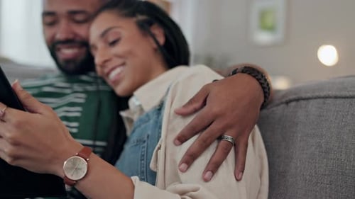 Happy Couple Relaxing Together on Sofa at Home