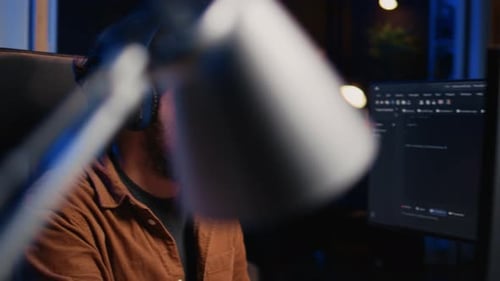 Informaticien écoutant de la musique tout en écrivant des lignes de Code en gros plan