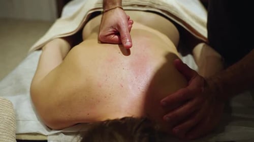 A Masseur is Giving a Back Massage to a Client - Close Up