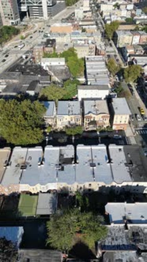Forward-moving drone shot over Jersey City displaying residential lines, angled intersections, and