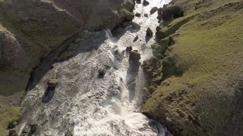 Aerial View Of Iceland Canyon With A Mountain River Flowing Through