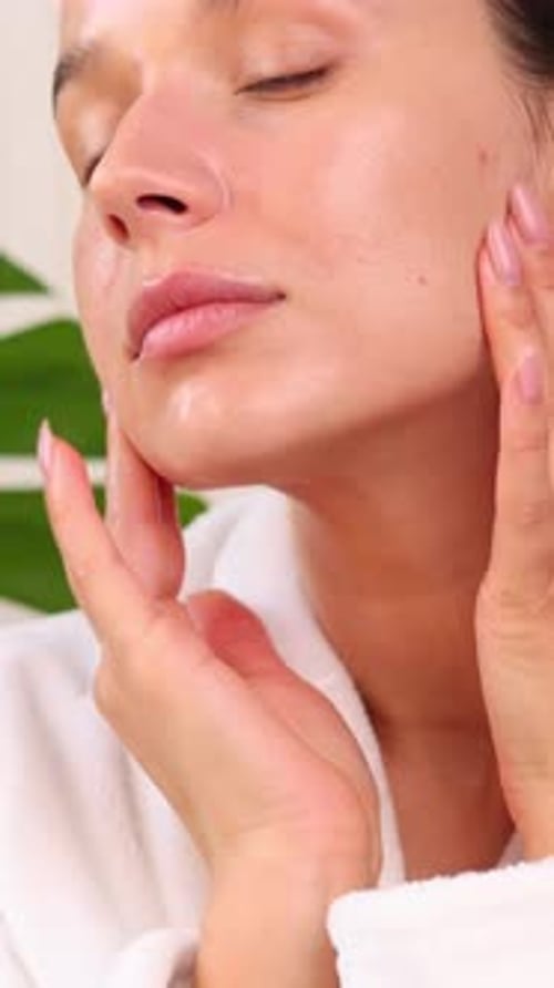 Woman Applying Lotion to Her Face