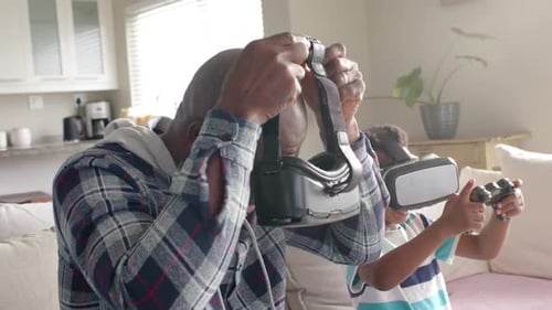Senior Adult and Boy Use Virtual Reality Headsets