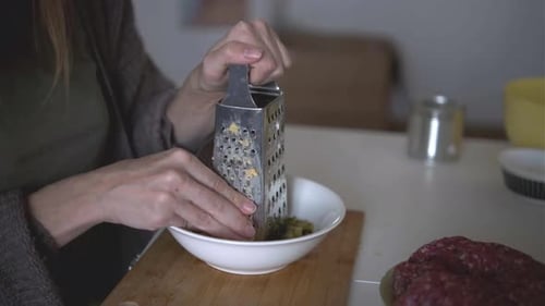 Woman Grating Cheese Into Bowl Cooking Homemade Meal