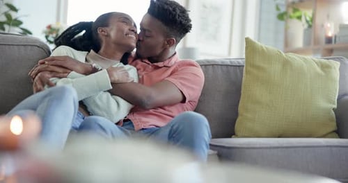 Couple Embraces on Couch with Love Indoors