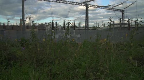Tilt up on a power station with power lines and electricity cables.