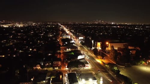 Aerial View of Metropolis at Night Lighted Boulevard in Urban Borough and High Rise Office Buildings