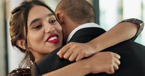 Smiling Woman Embracing a Man at a Wedding