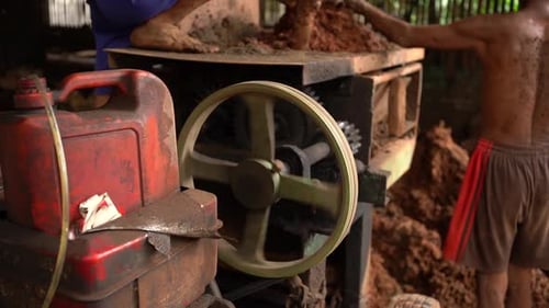 close up of gears rotating on an old namely a clay grinding