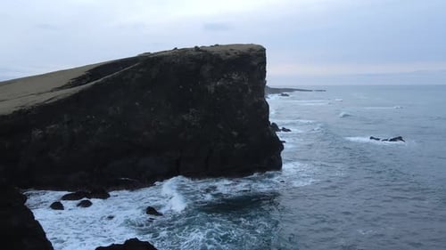 Aerial Seascape South Coast of Iceland. Waves Crashing to Black Rocks on Shore