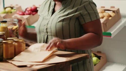 Woman Fills Bag with Pasta in Local Market