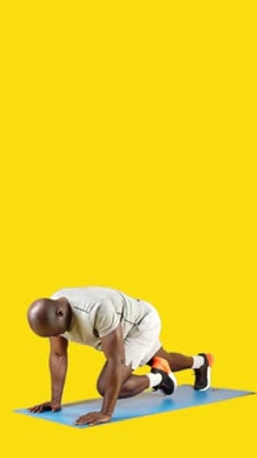 African Man Doing Mountain Climbers on a Mat