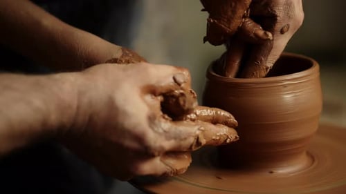 Unknown People Working With Wet Clay In Workshop. Closeup Unrecognized Masters Sculpting Pot In S...
