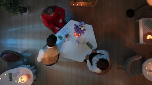 In the Shot Above a Young Couple is Sitting at a Table in a Cafe Restaurant and Talking About