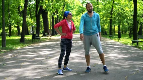 Couple of Joggers Resting After Jogging in the City Active