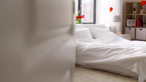 Romantic Bedroom Interior with Heart Balloons and Red Tulips