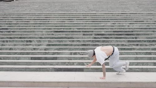 Agile Man Dancing Breakdance in Urban Setting
