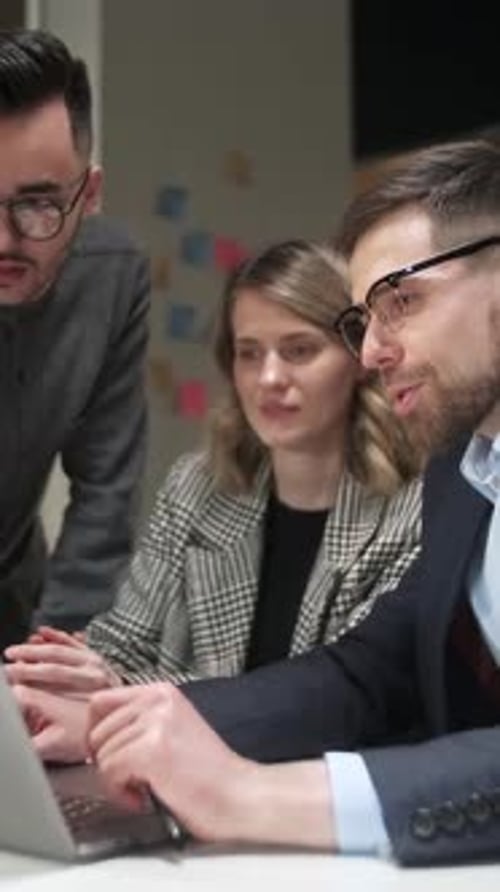 Colleagues And Clients Talking Strategy With Laptop And Tablet In Creative Office Productive