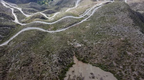 Flyover reveals twisted switchbacks as road descends mountain pass
