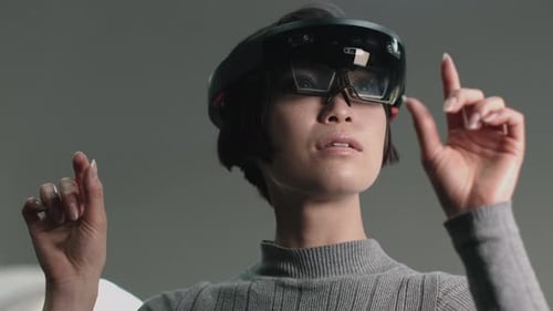 Asian female Using Virtual Reality in creative office