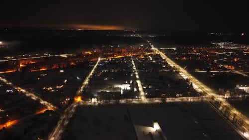 Snowy Cityscape Aerial View with Fireworks at Night