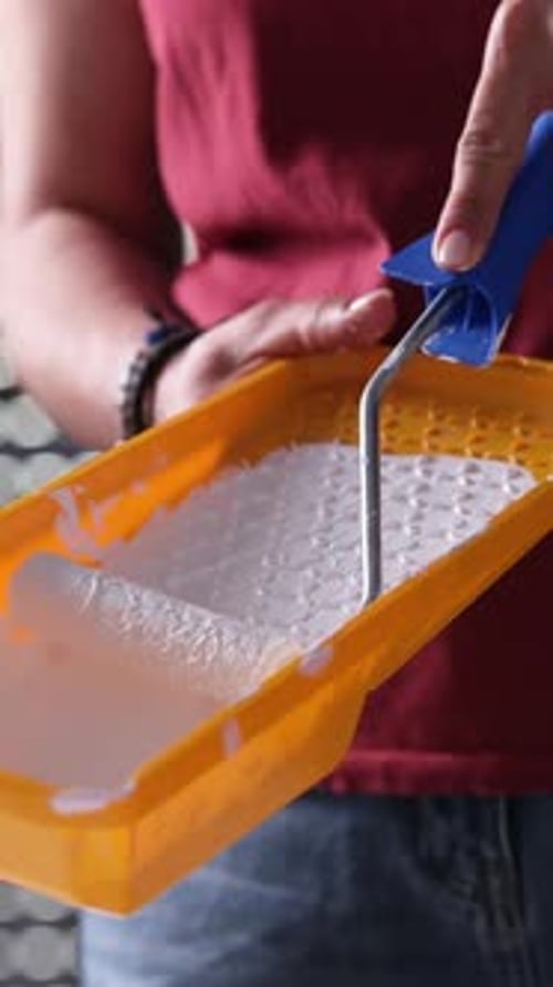 Girl Painting With White Paint And Roller