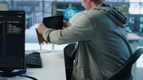 Two Men Coding at Computers in Modern Office