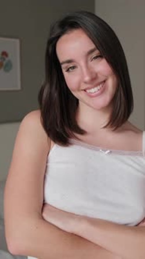 Smiling Young Woman Posing Indoors with Confidence