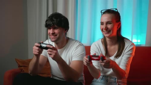 Couple Playing Video Games at Home on Couch