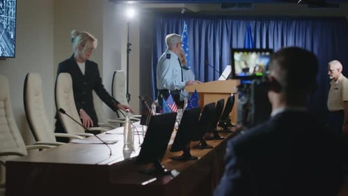 Press Conference with Officials at Podium and Table