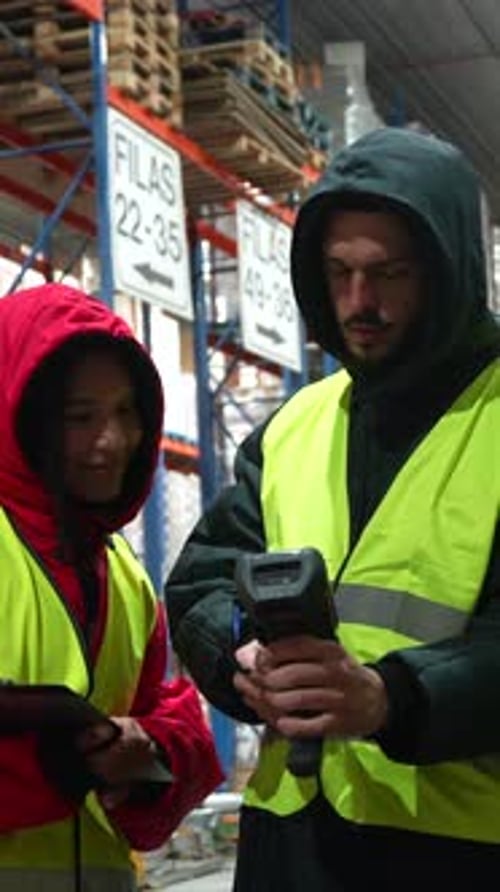 Warehouse Workers Managing Inventory in a Cold Storage Facility