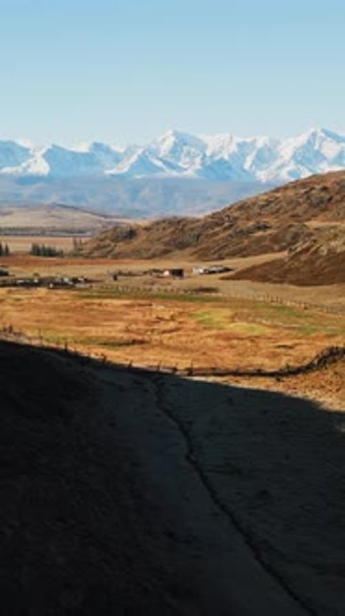 Serene Landscape Overlooking Mountains and Farmland in a Tranquil Rural Setting