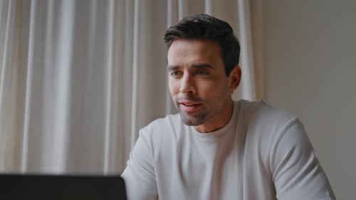 Young Adult Man Video Calling on Laptop