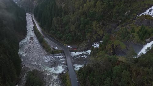 Latefossen waterfall running through rugged Norwegian countryside