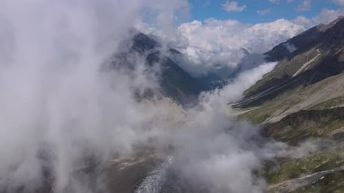 Beautiful Mountain Scenery with Swirling Clouds a Glacier and a Mountain Gorge