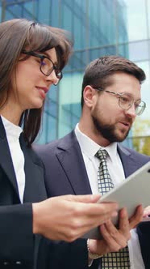 Side View of Two Successful Colleagues Man and Woman Having Outdoor Meeting Discussing Important
