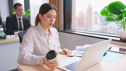 Asian beautiful businesswoman using laptop computer working in office.