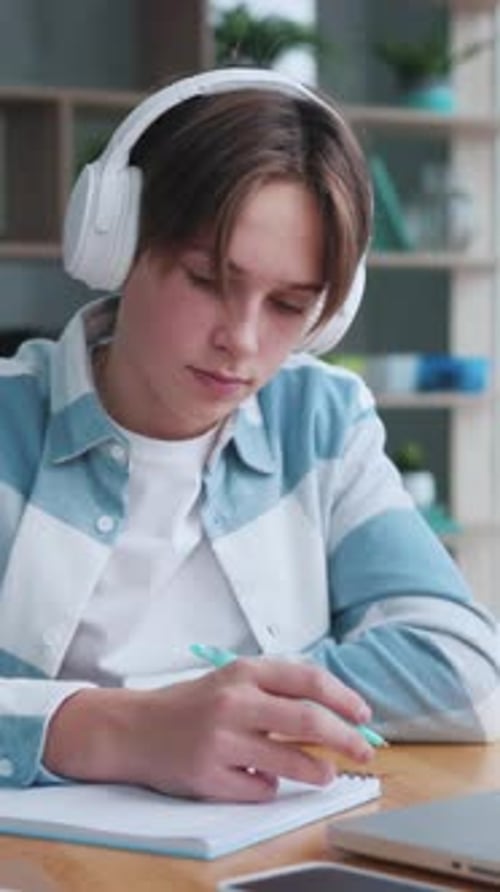 Teen Student Taking Notes at Desk