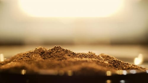 Macro Shot of Coffee Grounds Being Scooped at Sunrise, Indoors, Static