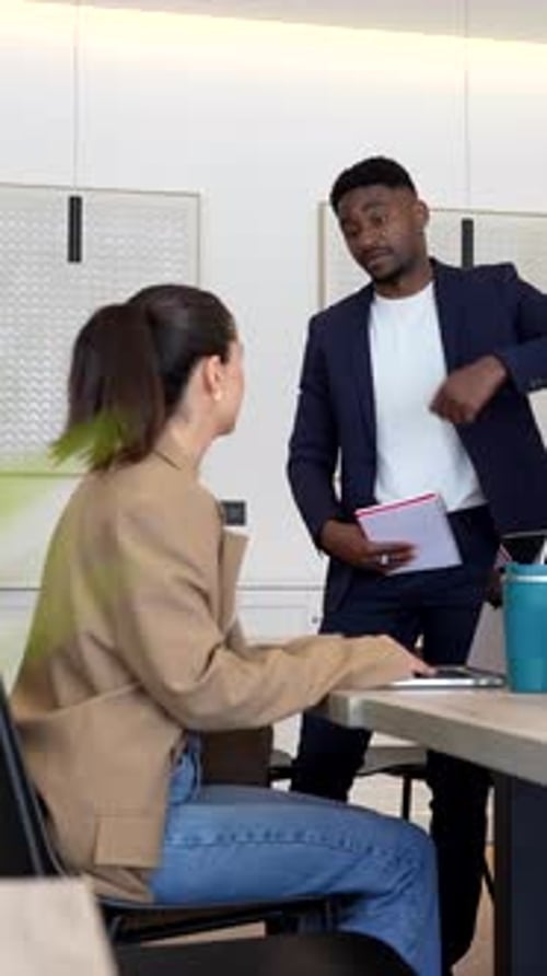 Managers presenting business ideas to colleagues in modern office