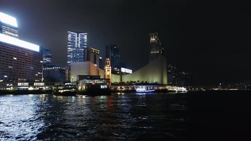 Nighttime Cityscape of Hong Kong with Illuminated Skyscrapers and Waterfront