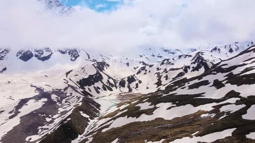 Alpine Scenery of Mountain Peaks in the Clouds Glacier and Mountain Lake