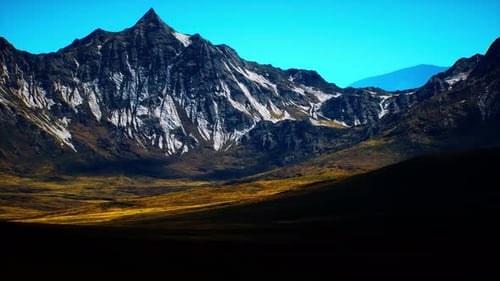 Majestic Mountain Landscape Under a Clear Blue Sky at Dawn