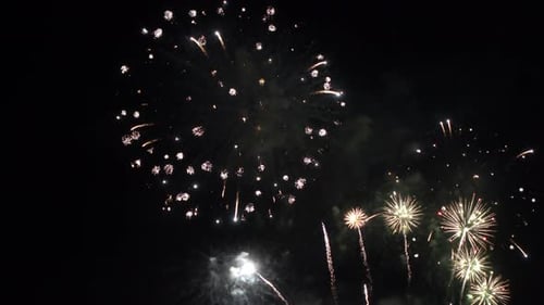 Massive fireworks in the black night sky.