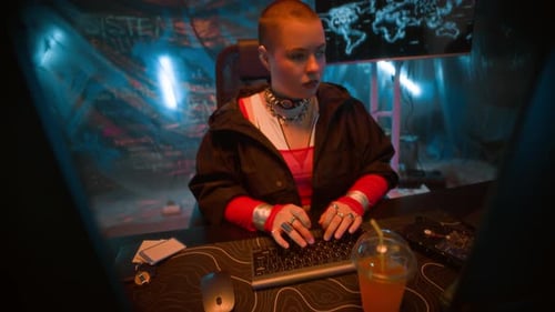 Futuristic Female Hacker Typing on Computer Keyboard in Neon Office