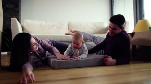 Happy Family Lying on Floor with Baby